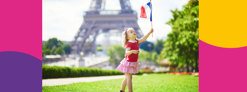 A girl holds a French flag, in front of the Eiffel Tower 