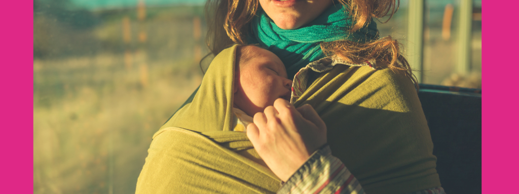 A mum carries a tiny baby in a sling