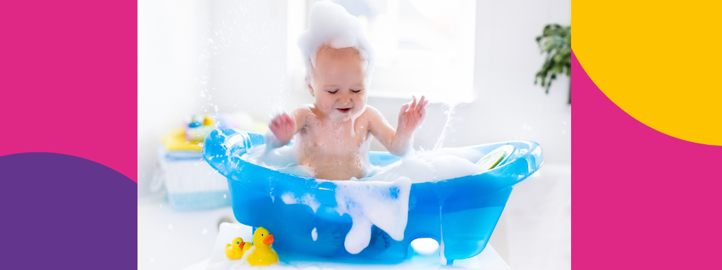 A baby splashes in a bath