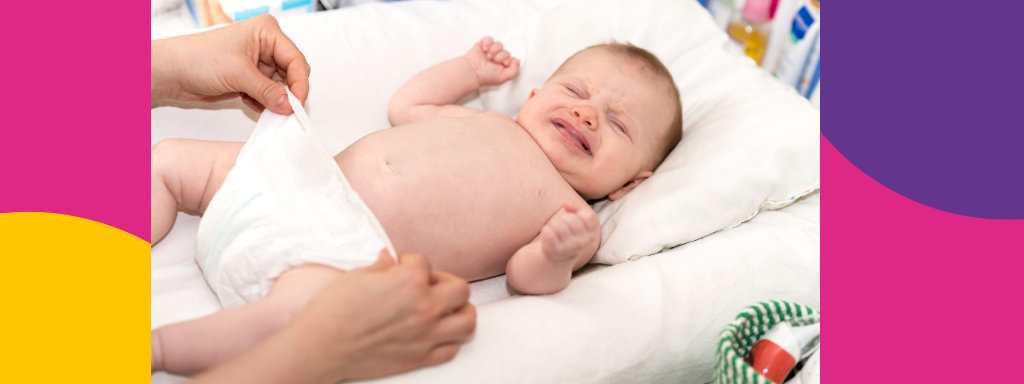 A baby is unsettled during a nappy change