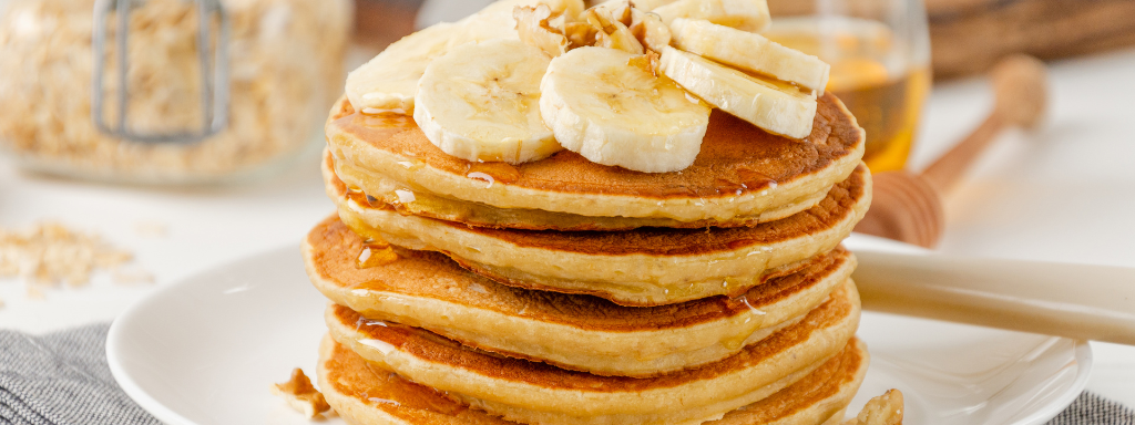 healthy toddler pancake toppings - the photo shows a stack of pancakes with sliced-up banana on top