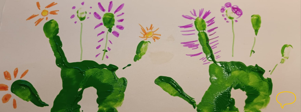 how to make a Valentine's Day card with your toddler
- image shows a child's handprints decorated so the fingers are flower stalks and flowers are drawn on around each finger and thumb, like a bunch of flowers