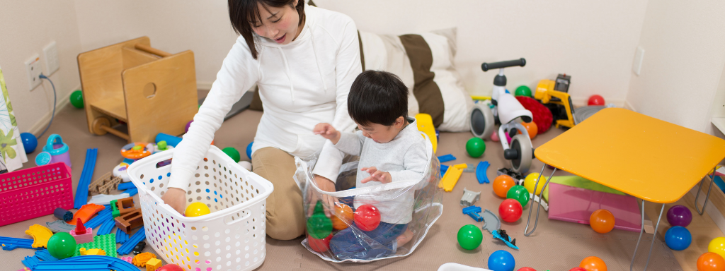 home organisation tips for parents - photo shows a mother and child sorting plastic balls into containers in a play room