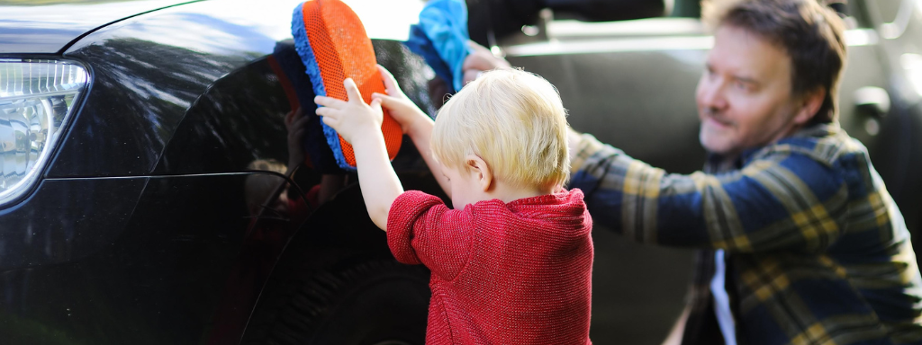 chores for under fives - the photo shows a toddler helping to wash the car