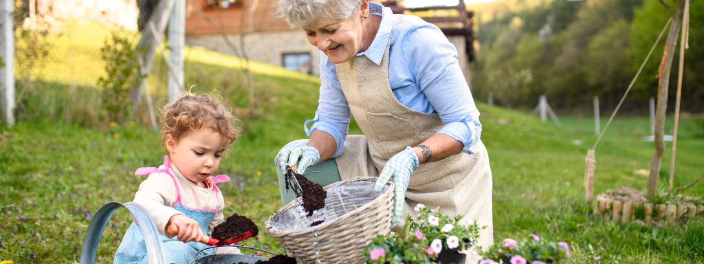 chores for under fives - the photo shows a child and adult using trowels to put soil into baskets