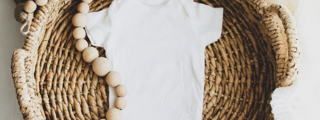 Clear Out Child's Old Clothes - the photo shows a baby vest in a wicker basket