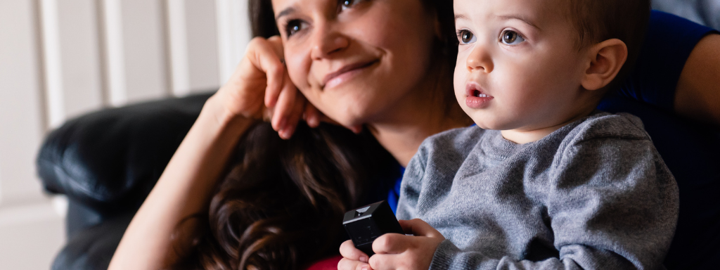 educational TV programmes for under fives - the photo shows a mum and toddler watching TV together